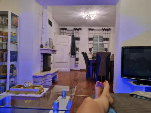 a person laying on a table in a living room at Landhaus Bia in Burig