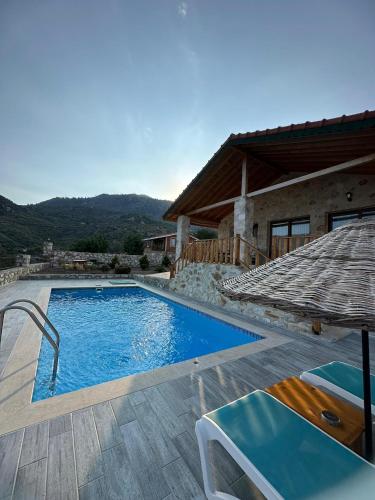 a swimming pool in front of a house at VILLA TERAS in Adrasan
