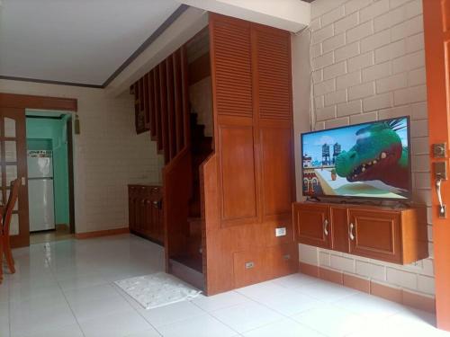a living room with a flat screen tv on a wall at Colorado Dos, Jubay Liloan Cebu in Cotcot