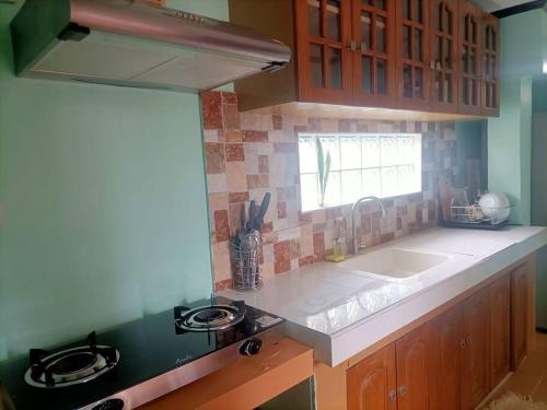 a kitchen with a sink and a counter top at Colorado Dos, Jubay Liloan Cebu in Cotcot