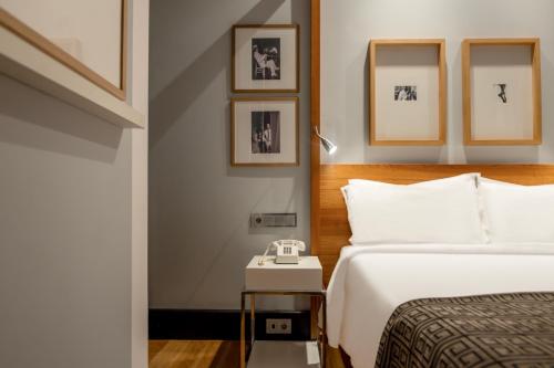 a hotel room with a bed and pictures on the wall at Browns Downtown Hotel in Lisbon