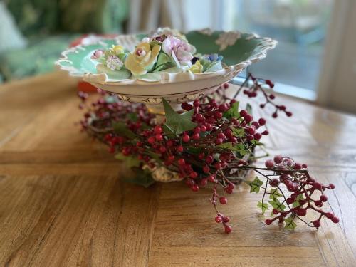 a bowl of flowers on top of a table at Walcot Yard with parking, Bath Keys in Bath