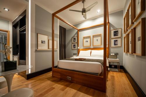 a bedroom with a canopy bed and a desk at Browns Downtown Hotel in Lisbon