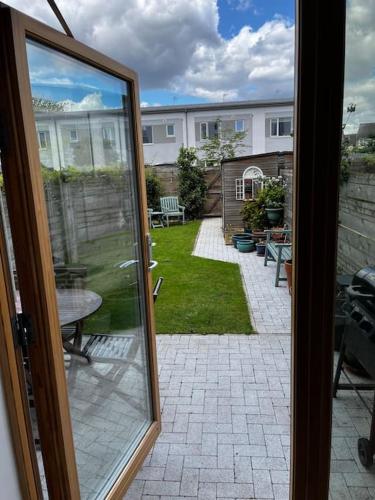 a sliding glass door to a patio with a yard at 2 Bedroom Eco House with South Facing Balcony in Nottingham