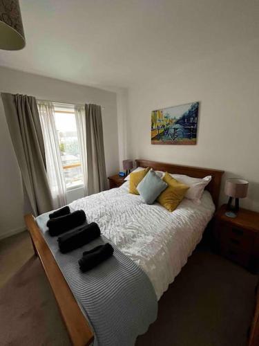a bedroom with a bed with black towels on it at 2 Bedroom Eco House with South Facing Balcony in Nottingham