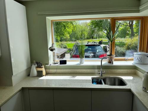 a kitchen counter with a sink and a window at 2 Bedroom Eco House with South Facing Balcony in Nottingham
