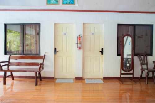 a room with three doors and a wooden floor at Balai La Niña Beach Resort in Carmen
