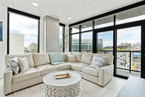 a living room with a white couch and large windows at 2bd 2ba Best style and location Pool spa gym pkg! in American Towers Condominium