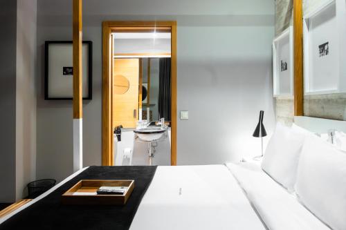 a bedroom with a large bed and a sink at Browns Downtown Hotel in Lisbon