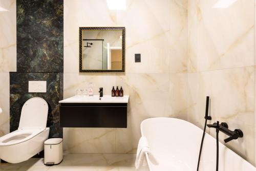 a bathroom with a toilet and a sink at Palm House Boutique Hotel and Spa in Cape Town
