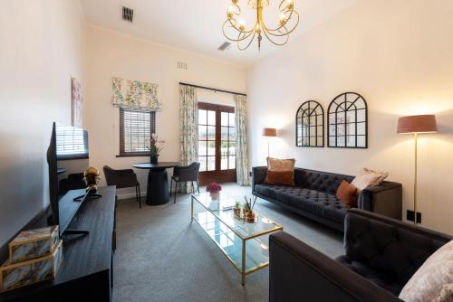 a living room with a couch and a table at Palm House Boutique Hotel and Spa in Cape Town