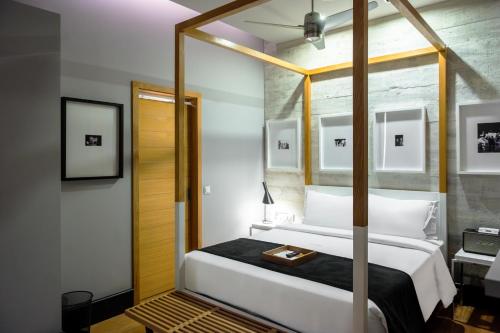 a bedroom with a large bed with a mirror at Browns Downtown Hotel in Lisbon