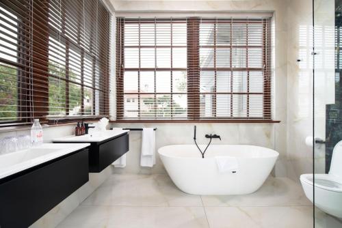 a bathroom with a large tub and two sinks at Palm House Boutique Hotel and Spa in Cape Town