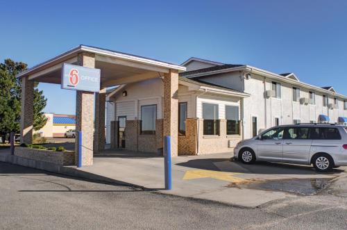a car parked in a parking lot in front of a house at Motel 6-Colby, KS in Colby