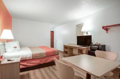 a small hotel room with a bed and a desk at Motel 6-Colby, KS in Colby