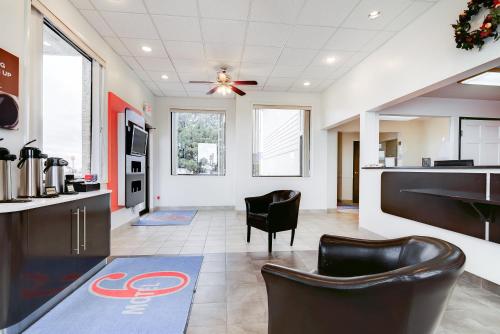a large kitchen with black chairs and a ceiling fan at Motel 6-Colby, KS in Colby