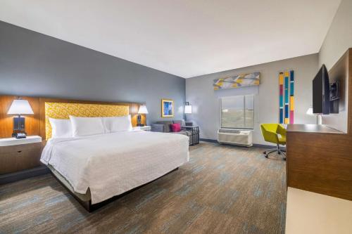 a hotel room with a bed and a television at Hampton Inn & Suites Brenham in Brenham