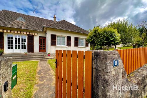 a house with a wooden gate in front of it at Family Home and Nature in Eymoutiers in Eymoutiers