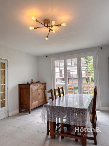 a dining room with a table and chairs at Family Home and Nature in Eymoutiers in Eymoutiers