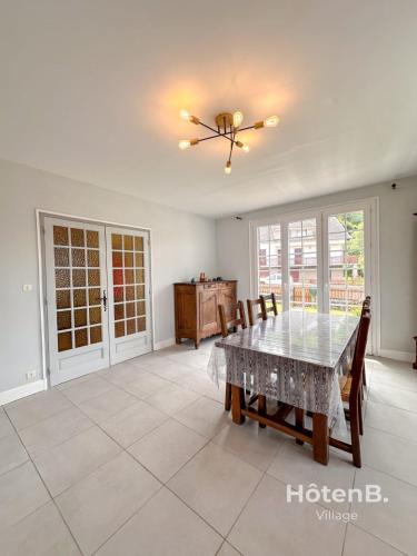 a dining room with a table and chairs at Family Home and Nature in Eymoutiers in Eymoutiers