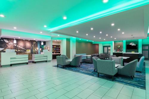 a lobby of a hotel with chairs and tables at La Quinta by Wyndham Cullman in Cullman
