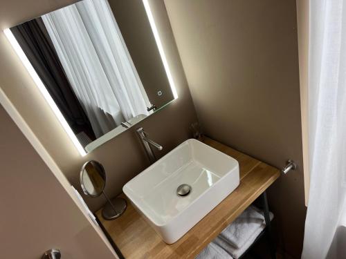 a bathroom with a white sink and a mirror at Manoir Nestor - Chairière in Vresse-sur-Semois