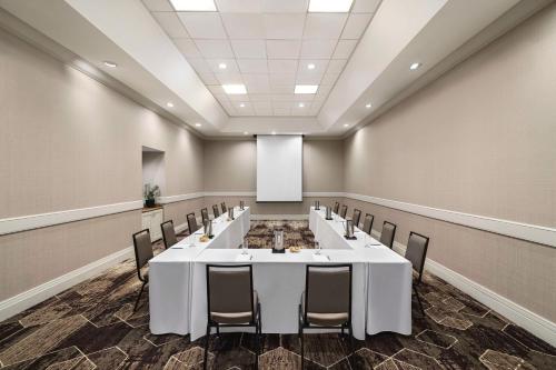 a conference room with a large white table and chairs at Embassy Suites by Hilton Phoenix Downtown North in Phoenix