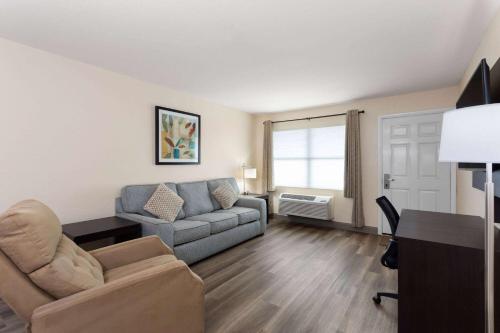 a living room with a couch and a chair at Baymont by Wyndham Punta Gorda/Port Charlotte in Punta Gorda