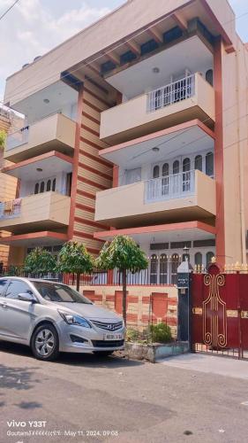 a car parked in front of a building at AKG INN Kolkata in Salt Lake City
