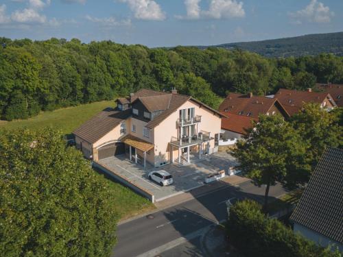 an aerial view of a large house with a yard at MEMORY - Ferienapartments & Zimmer - Mediterraner Flair in der Rhön in Bischofsheim an der Rhön