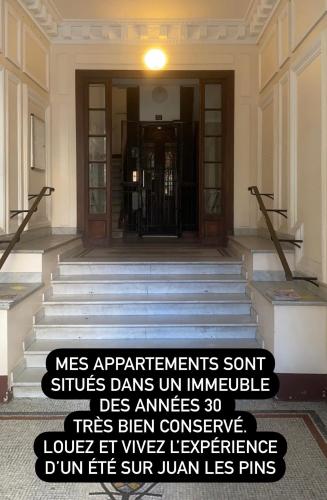 a sign is posted in front of a building at STUDIO NEUF ET PROCHE DES PLAGES DE JUAN LES PINS in Juan-les-Pins