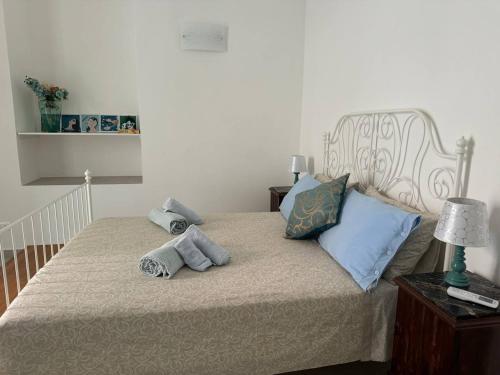 a bedroom with a bed with towels on it at Casa Ortensia in Santa Teresa di Riva