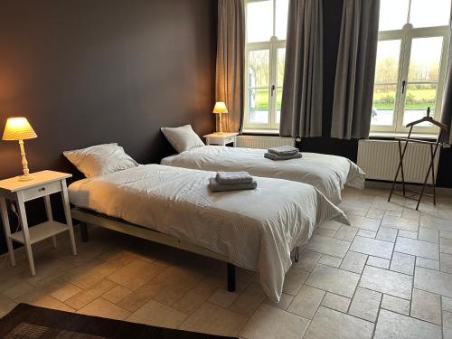 Ένα ή περισσότερα κρεβάτια σε δωμάτιο στο Onder de Toren