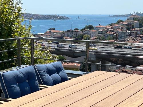 a table and chairs on a balcony with a view of a city at Mona Bosphorus in Istanbul