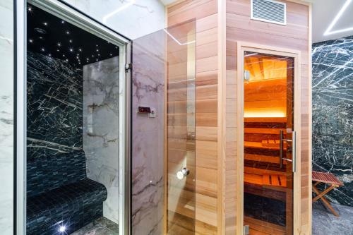 a shower with a glass door in a bathroom at Apartmány Jakub in Příseka