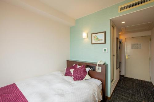 Ein Bett oder Betten in einem Zimmer der Unterkunft Hotel Claire Higasa