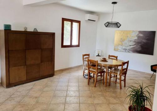 a dining room with a table and chairs at Maison agréable avec grands volumes in Levie