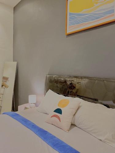 a bedroom with a bed with a pillow on it at Robiu Bed & Breakfast in Banyuwangi