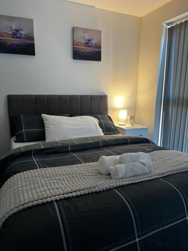 a bedroom with a bed with two towels on it at X marina breeze x in Swansea
