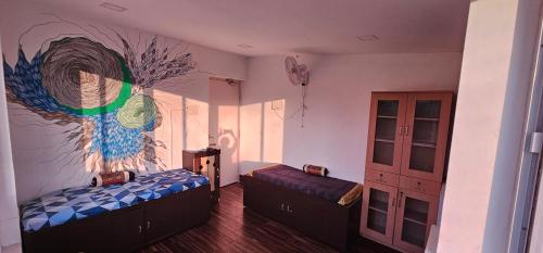 a room with two beds and a painting on the wall at Suave 2bhk in Chennai