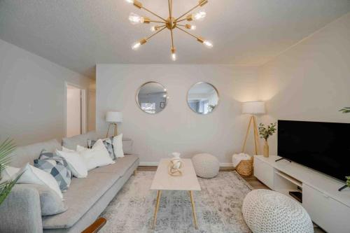 a living room with a couch and a flat screen tv at Stunning 4BR 2BA Hot Tub Cozy Holiday Home in Plano in Plano