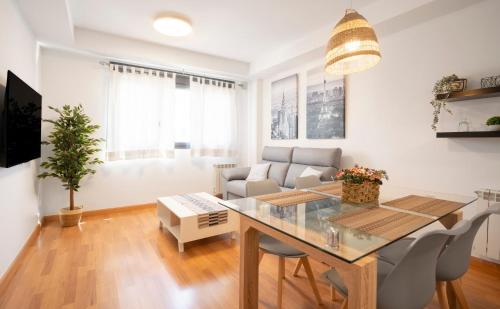 a living room with a table and a couch at EnjoyGranada EMIR 3B y Parking in Granada