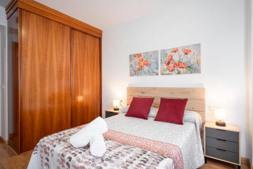 a bedroom with a bed with a stuffed animal on it at EnjoyGranada EMIR 3B y Parking in Granada