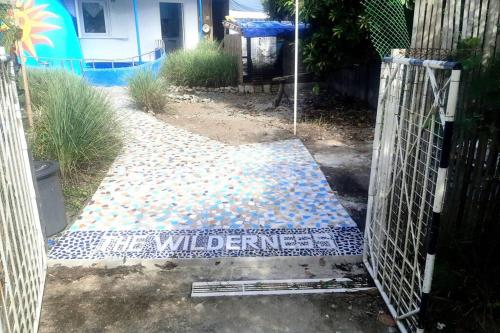 a gate with a welcome mat in front of a house at Seabreeze Guesthouse in Mocpoc Sur