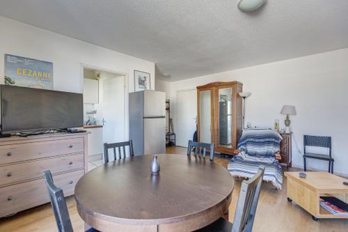 une salle à manger avec une table en bois et une cuisine dans l'établissement GuestReady - Beau Séjour près de Saint-Michel, à Bordeaux