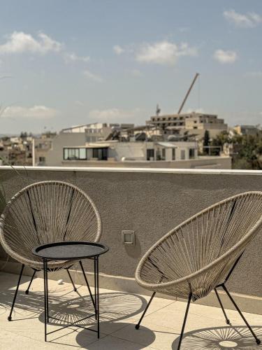a pair of chairs and a table on a balcony at The Roof Top - By Solea in Ħal Balzan