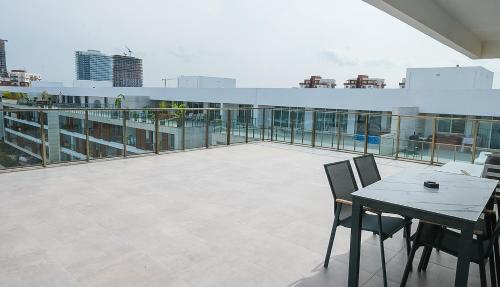 a balcony with a table and chairs on a building at xo courtyard long beach in Iskele