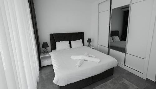 a bedroom with a bed with a towel on it at xo courtyard long beach in Iskele