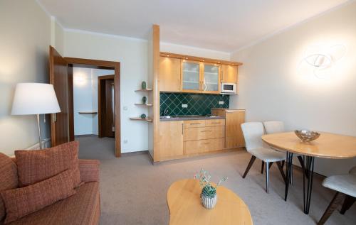 a living room with a couch and a table at Die WUNDER s Ferienpension in Pörtschach am Wörthersee