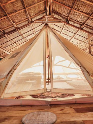 a tent is set up on a wooden floor at Kubo ni Apple in Tagbina